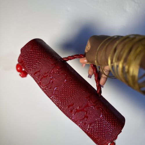 Red cylindrical handmade leather bag