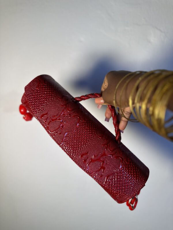 Red cylindrical handmade leather bag