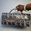 Handmade leather curved flap bag in chocolate snake skin