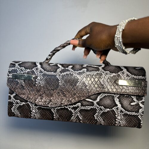 Handmade leather curved flap bag in chocolate snake skin