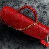Red cylindrical leather bag